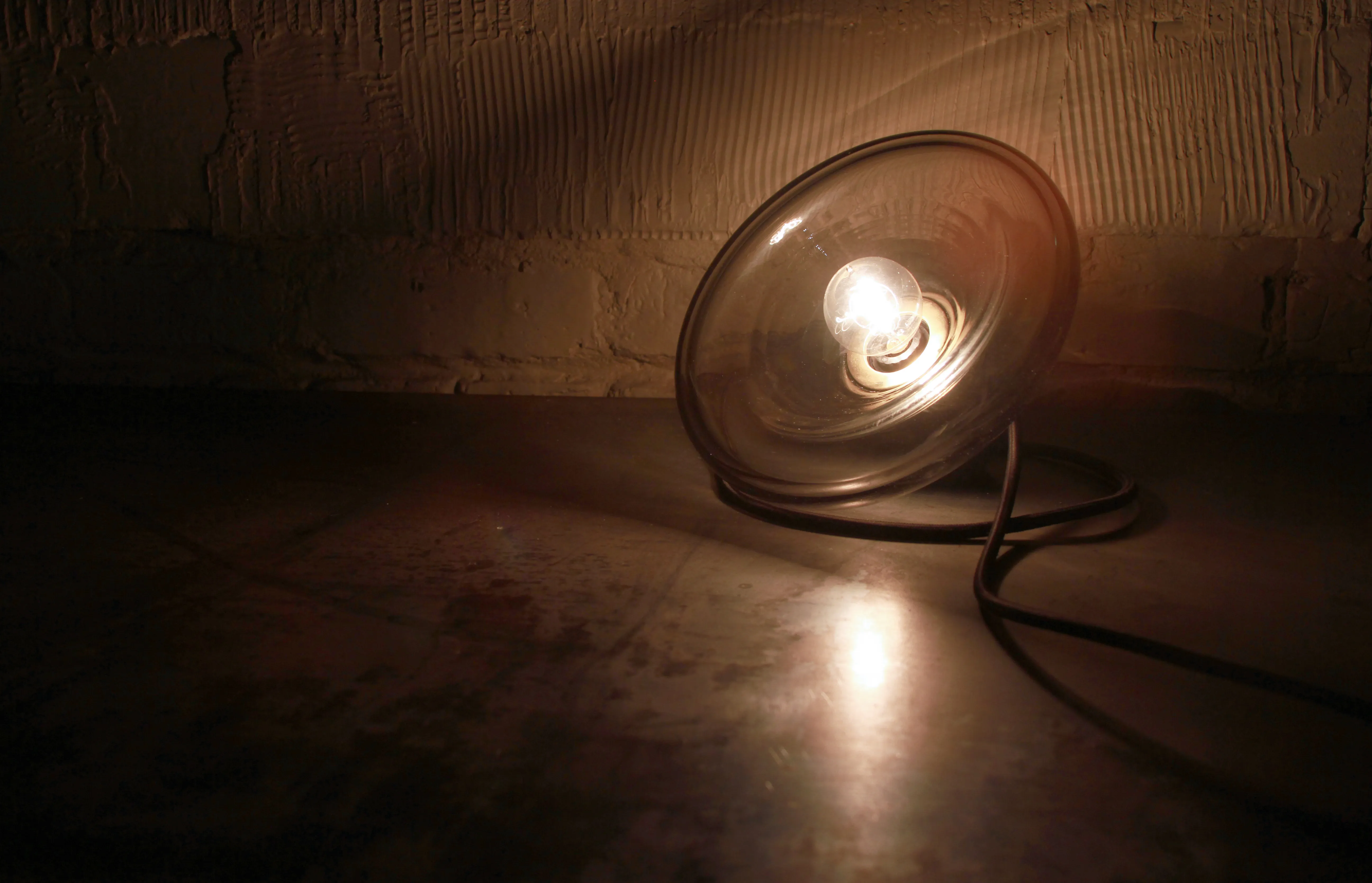 ChiLab's Boolean Lamp: a hand-blown glass pendant in smoke glass on a cast-concrete base.