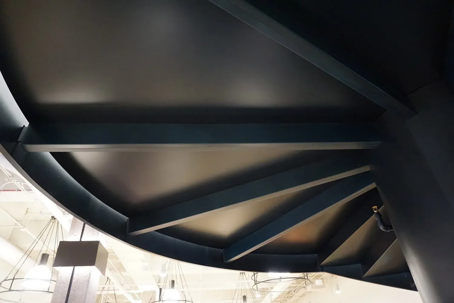 The Grand Spiral Stair viewed from below, showing the helical descent through the floor plate.